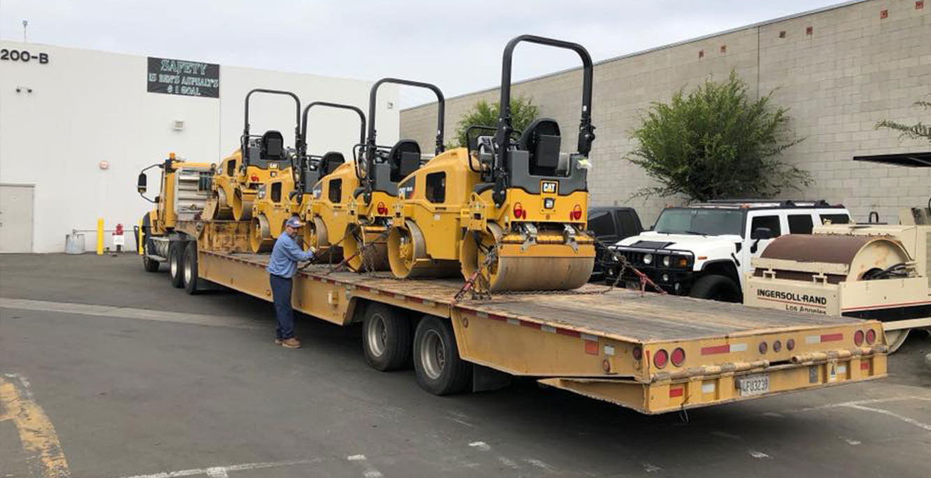 Ben's Express hauling multiple machineries on trailer